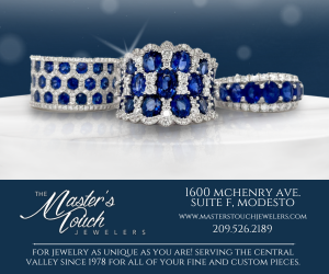 Three sapphire and diamond rings sit on a white surface against a blue gradient ad banner for The Master’s Touch Jewelers in Modesto.