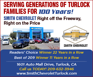 Promotional banner for Smith Chevrolet, Turlock, CA, celebrating 100 years of serving generations, with a row of cars in front of the dealership.
